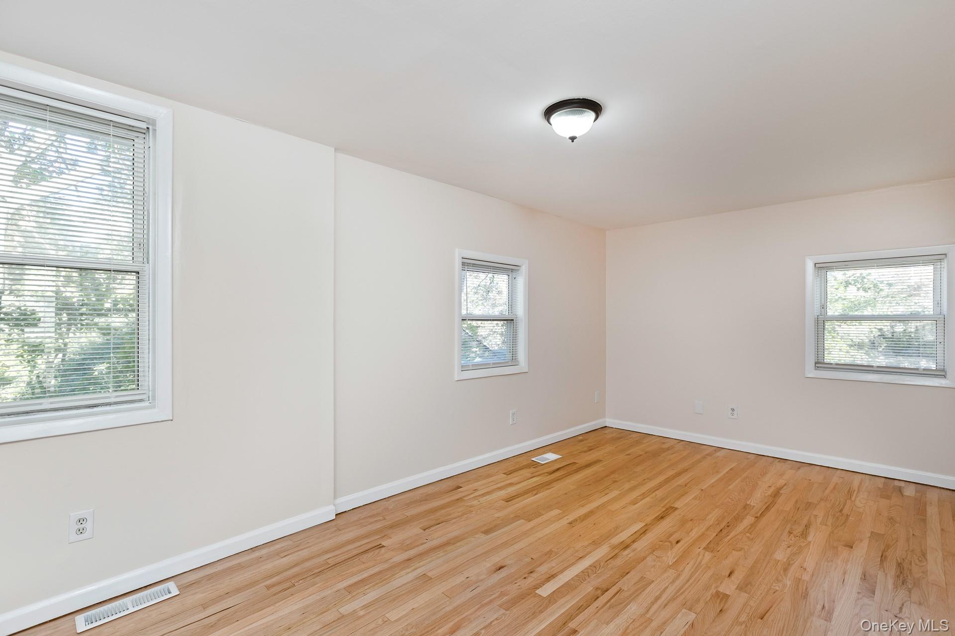 860 Flanders Road Flanders, NY 11901 - Photo 23 of 31 a view of empty room with wooden floor and fan