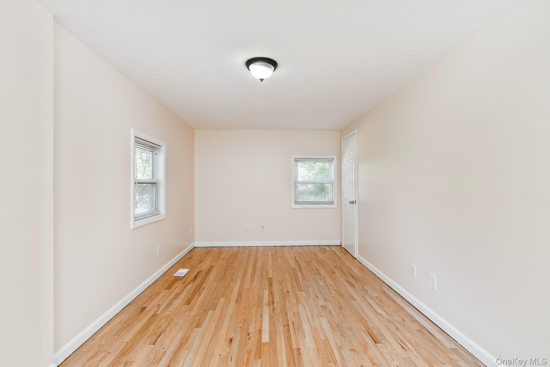 860 Flanders Road Flanders, NY 11901 - Photo 24 of 31 a view of a room with wooden floor and windows