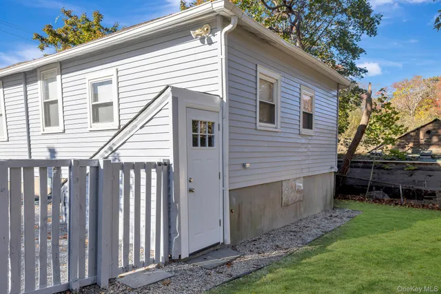 a view of a small house with a yard