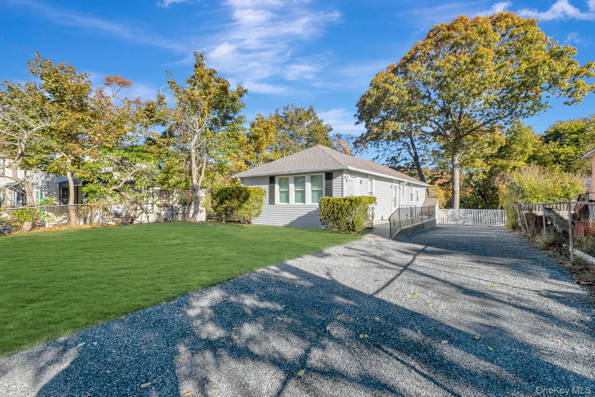 860 Flanders Road Flanders, NY 11901 - Photo 6 of 31 View of side of property featuring driveway