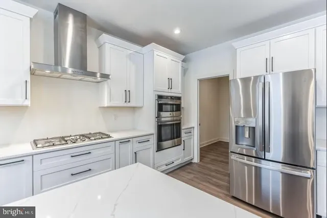 a kitchen with stainless steel appliances a refrigerator sink and cabinets