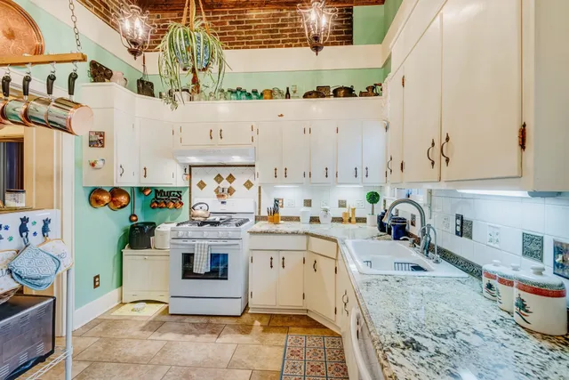a kitchen with cabinets and wooden floor