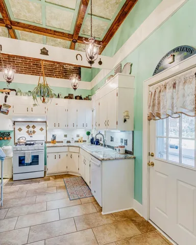 a view of kitchen with furniture and refrigerator