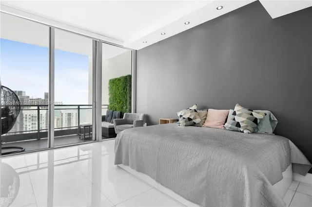 a bedroom with a bed and a large window