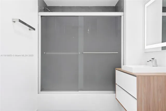 a bathroom with a sink and mirror