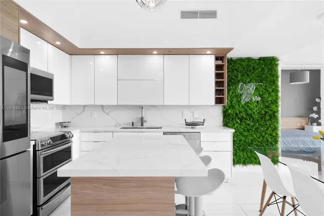 a kitchen with a stove a sink and a microwave