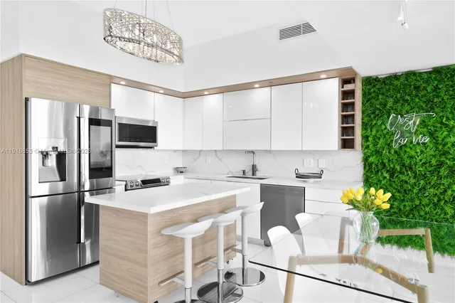 a kitchen with a stove a refrigerator and a oven