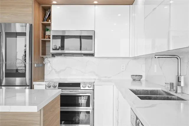 a kitchen with granite countertop a sink and a stove top oven