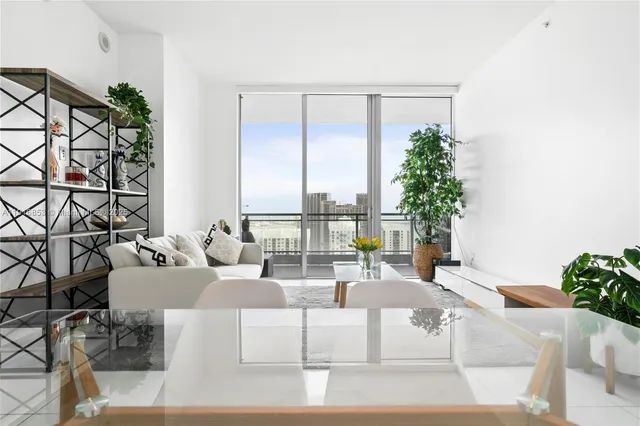 a living room with furniture and potted plant