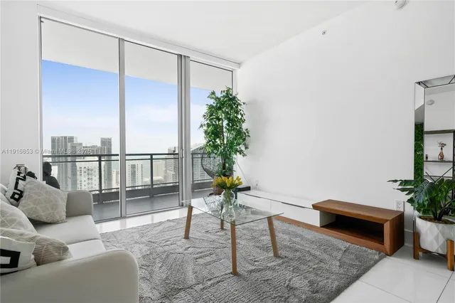 a living room with furniture plant and a potted plant
