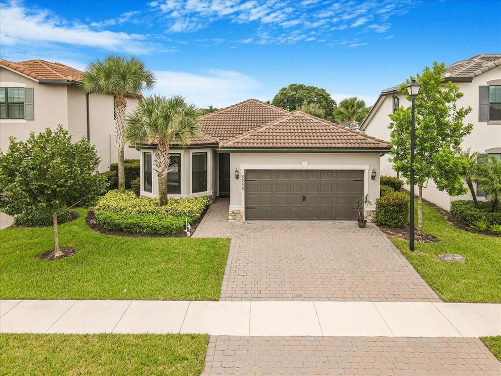 8258 Northwest 79th Avenue Tamarac, FL 33321 - Photo 1 of 38 a front view of a house with a yard