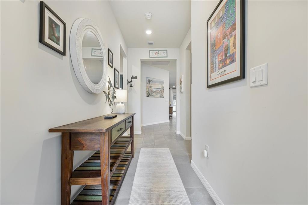 8258 Northwest 79th Avenue Tamarac, FL 33321 - Photo 20 of 38 a view of a hallway with entryway wooden floor and front door