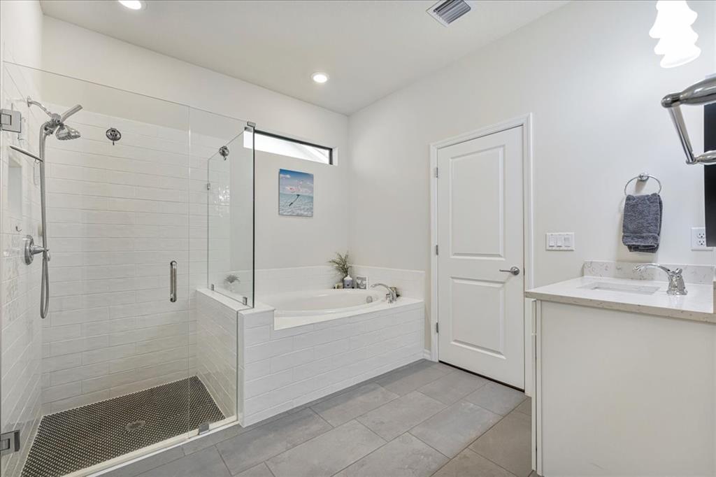 8258 Northwest 79th Avenue Tamarac, FL 33321 - Photo 25 of 38 a bathroom with a bathtub sink a mirror and shower