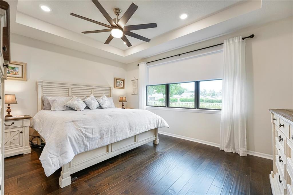 8258 Northwest 79th Avenue Tamarac, FL 33321 - Photo 27 of 38 a bedroom with a large bed chandelier and a window