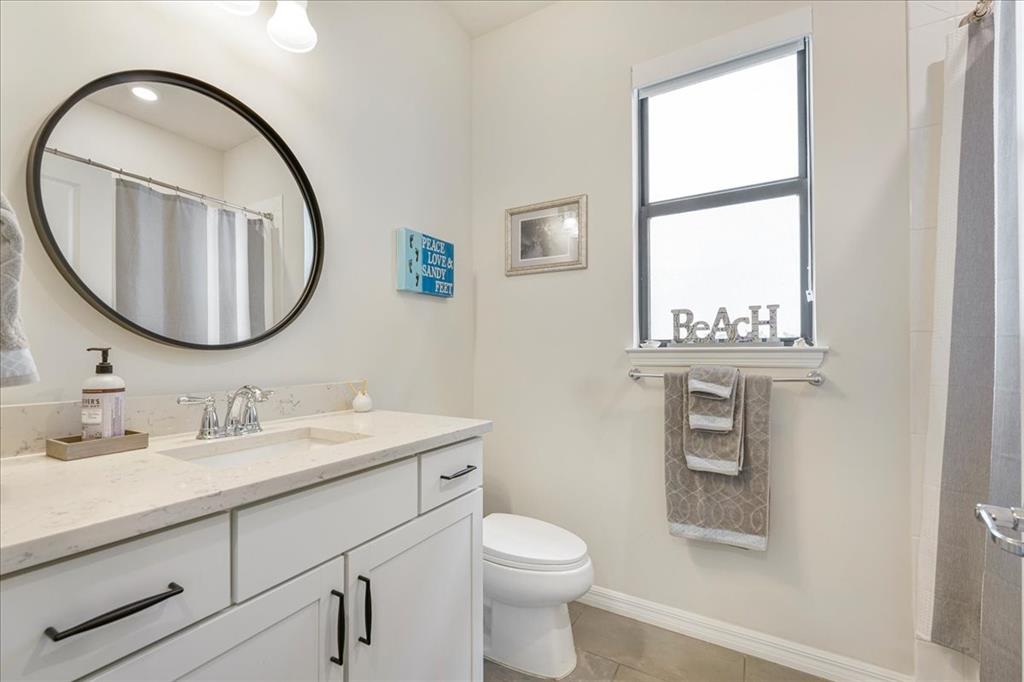 8258 Northwest 79th Avenue Tamarac, FL 33321 - Photo 36 of 38 a bathroom with a toilet a sink and mirror