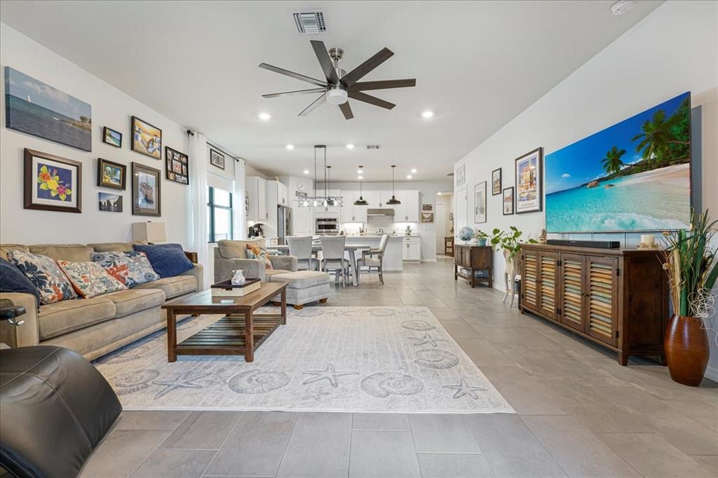 8258 Northwest 79th Avenue Tamarac, FL 33321 - Photo 5 of 38 a living room with furniture a ceiling fan and a rug