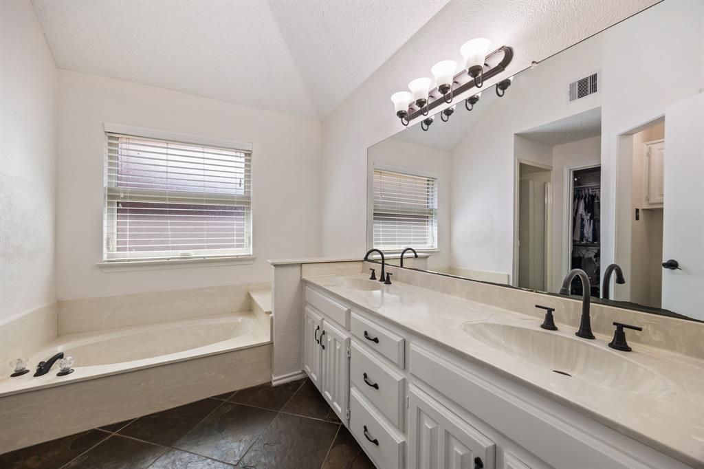 2807 Silverspring Road Carrollton, TX 75006 - Photo 22 of 37 The en suite bath includes a dual-sink vanity, oversized mirror and generous counter space.