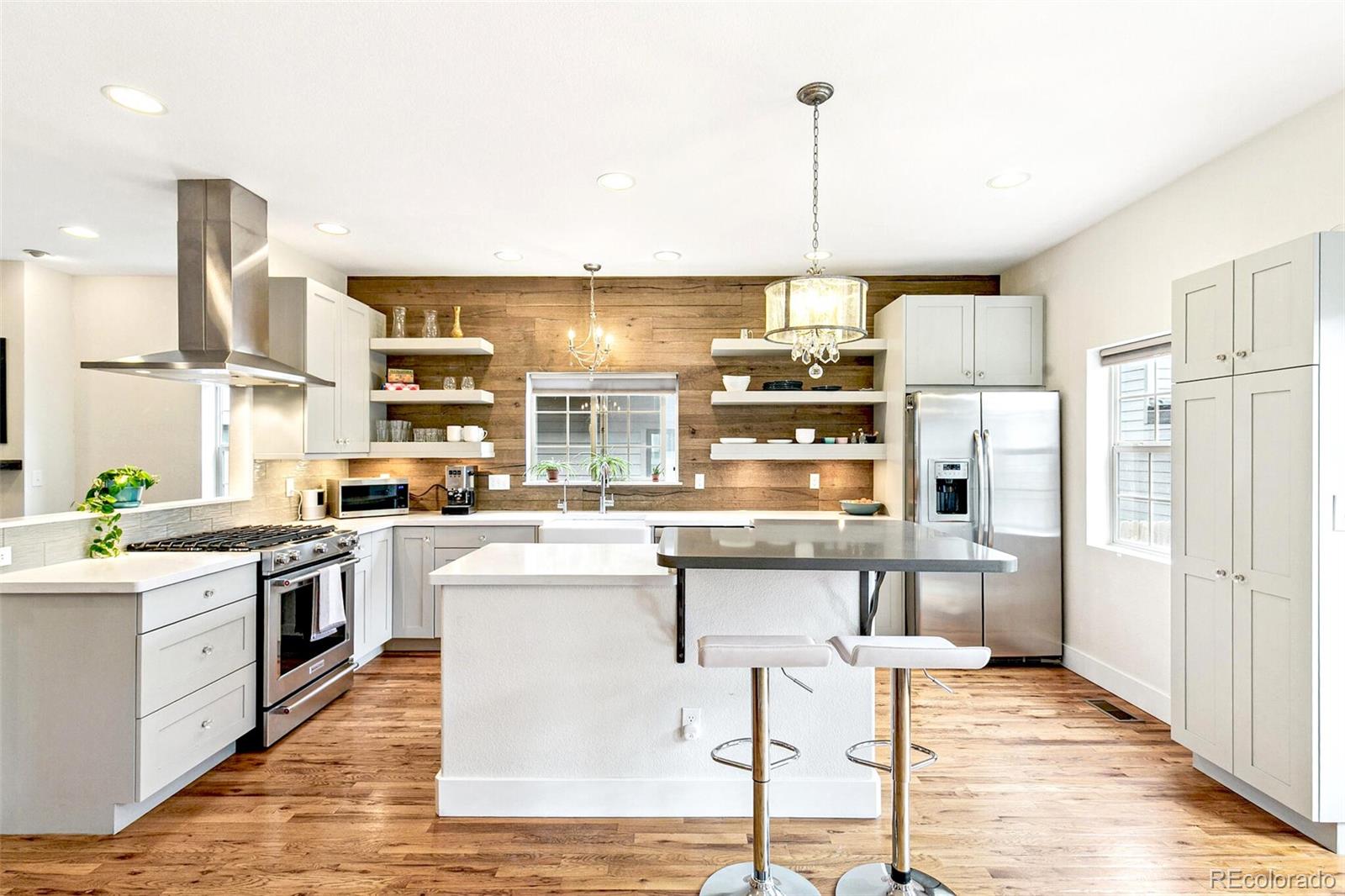 4530 Quitman Street Denver, CO 80212 - Photo 16 of 50 a kitchen with stainless steel appliances granite countertop a stove and refrigerator