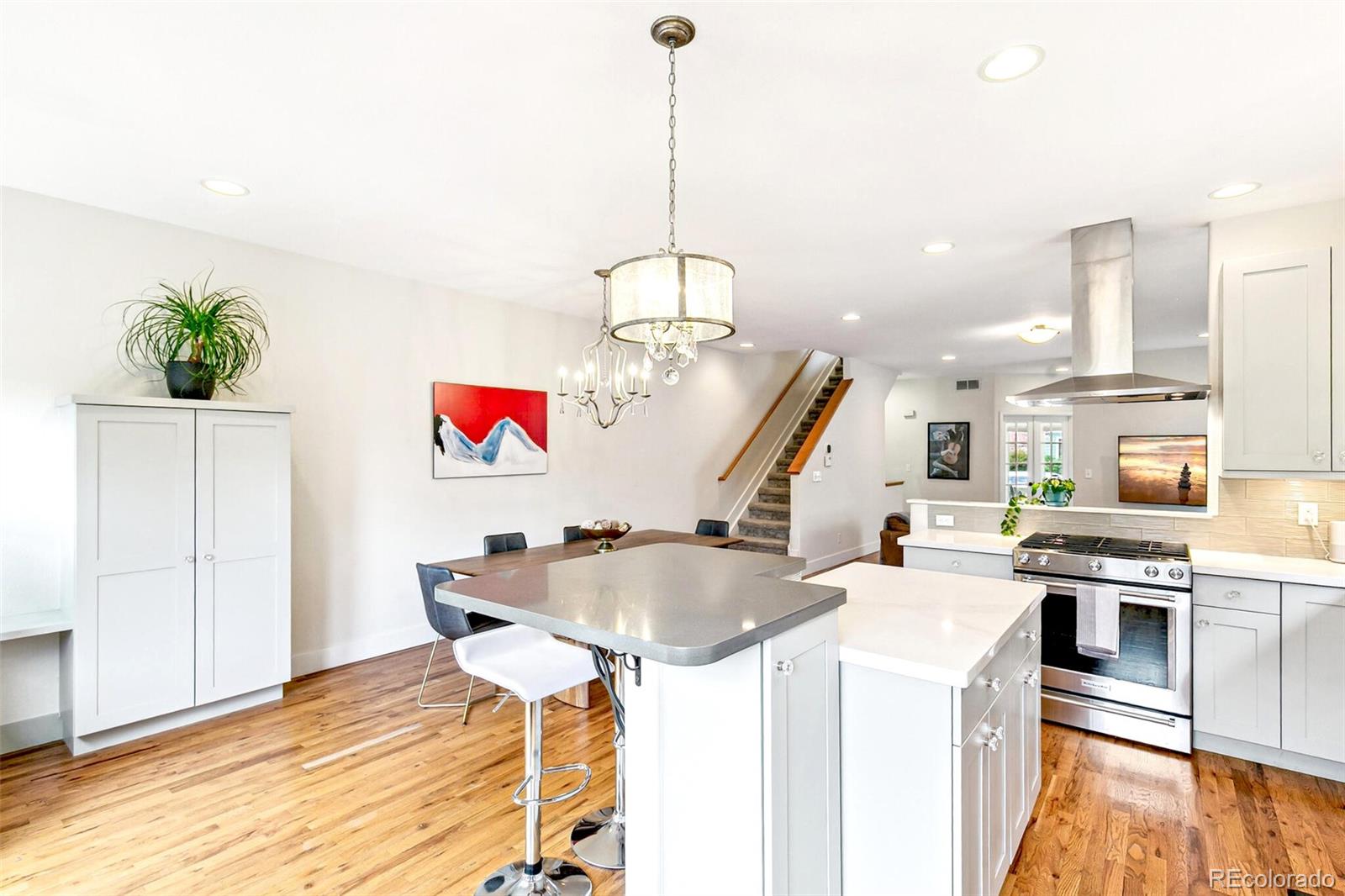 4530 Quitman Street Denver, CO 80212 - Photo 19 of 50 a kitchen with stainless steel appliances granite countertop a sink a stove and a wooden floors