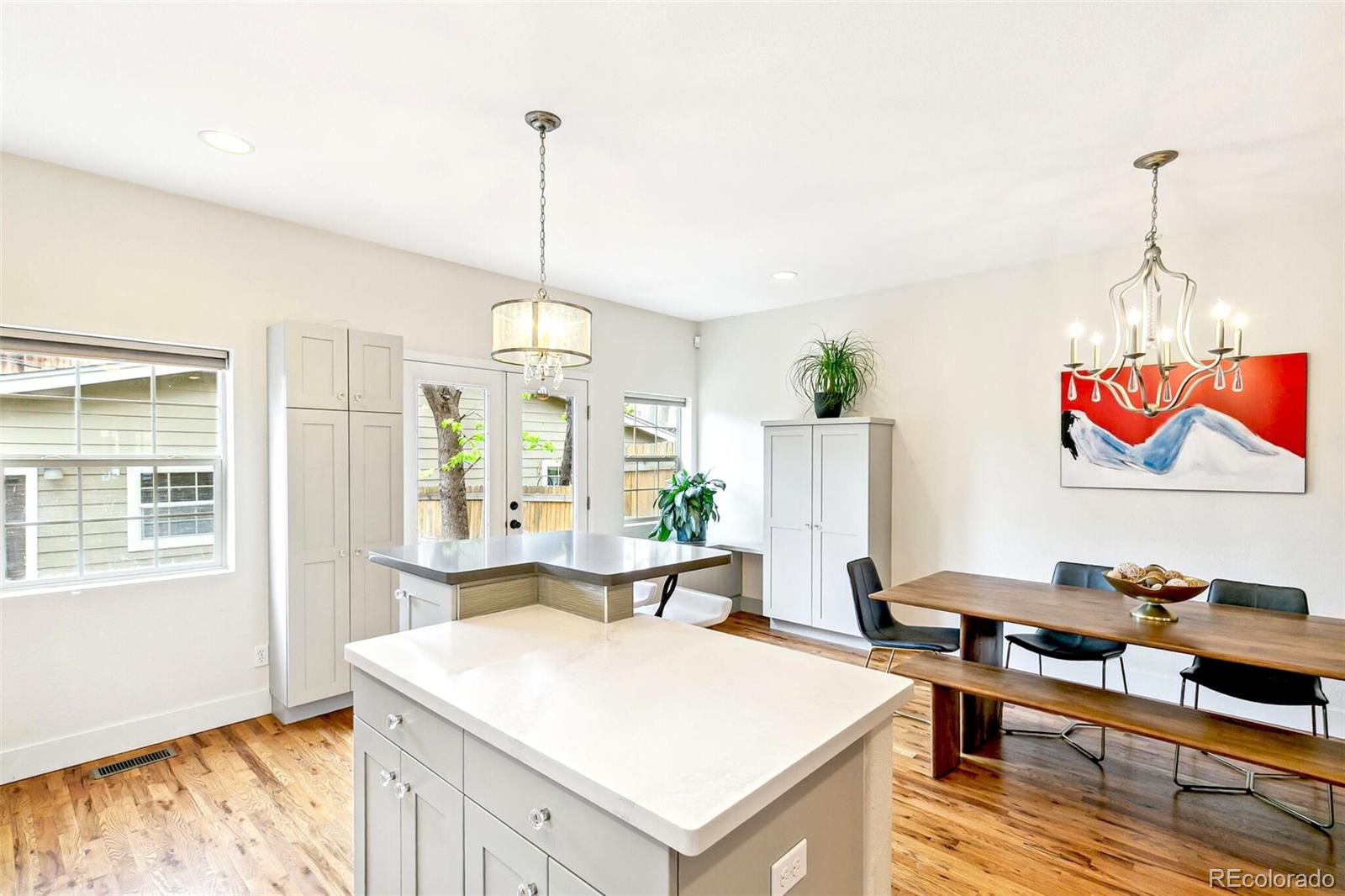 4530 Quitman Street Denver, CO 80212 - Photo 20 of 50 a living room with dining table and a wooden floor