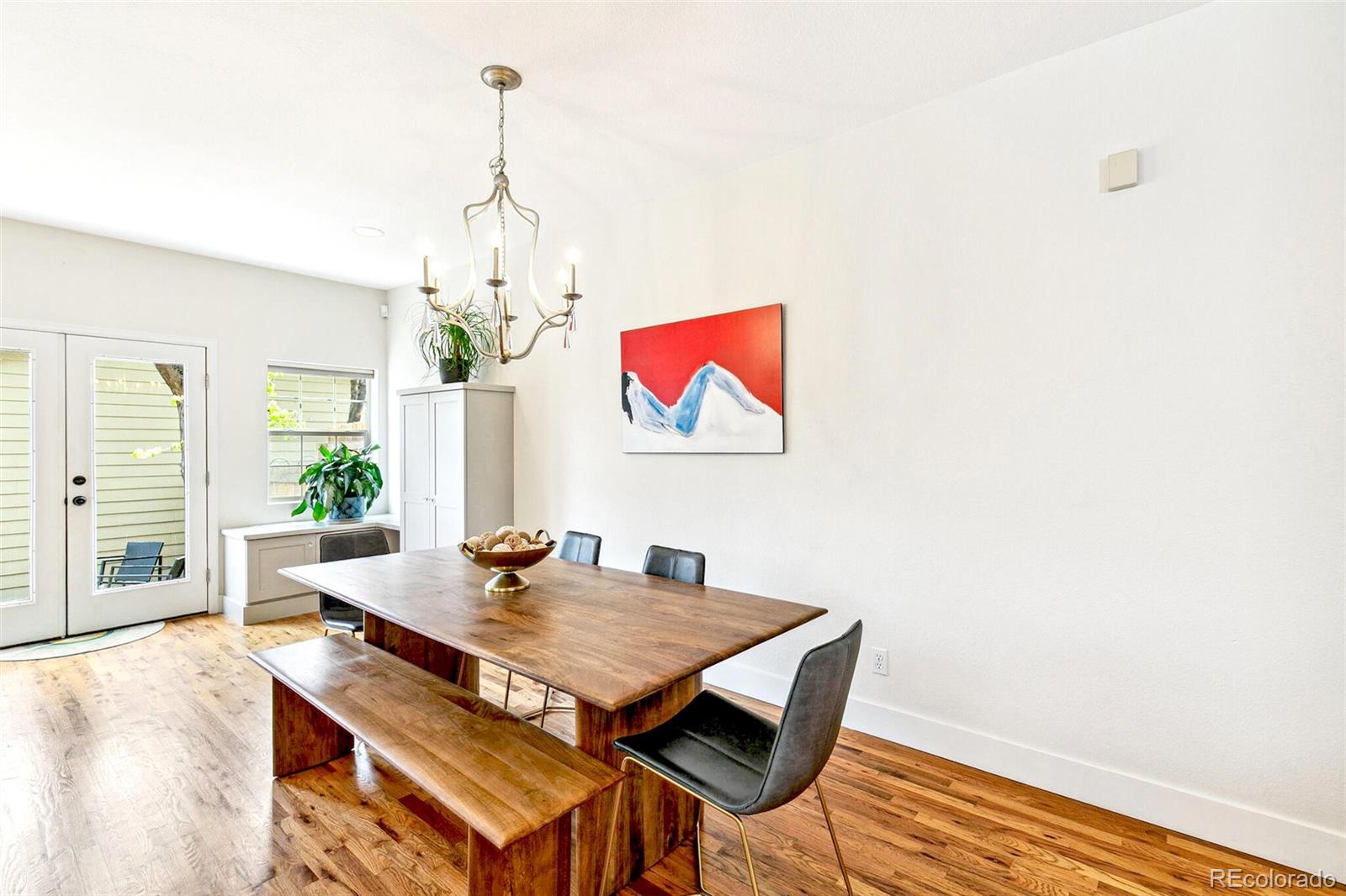 4530 Quitman Street Denver, CO 80212 - Photo 22 of 50 a view of a dining room with furniture wooden floor and chandelier