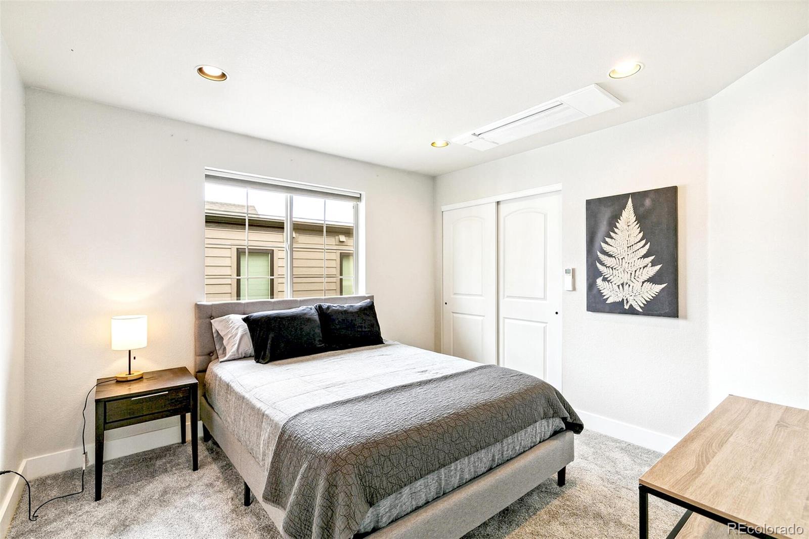 4530 Quitman Street Denver, CO 80212 - Photo 30 of 50 a bedroom with a bed and a painting on the wall