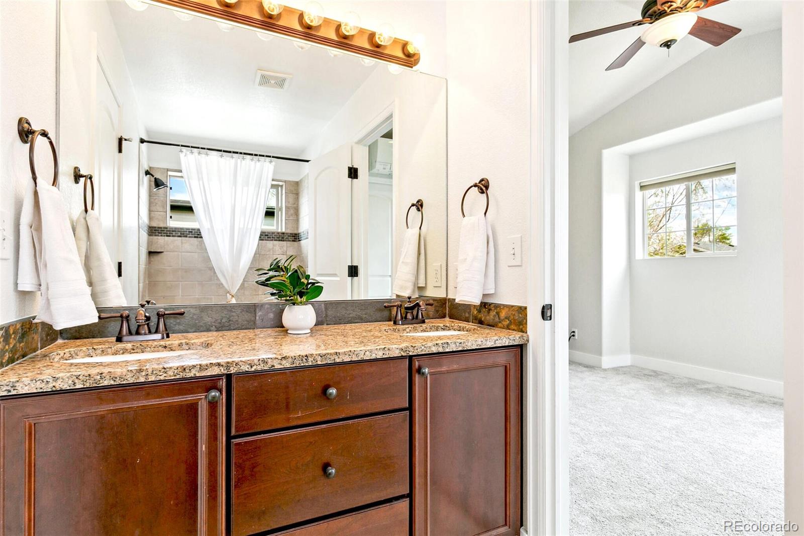 4530 Quitman Street Denver, CO 80212 - Photo 33 of 50 a bathroom with a granite countertop sink and a mirror