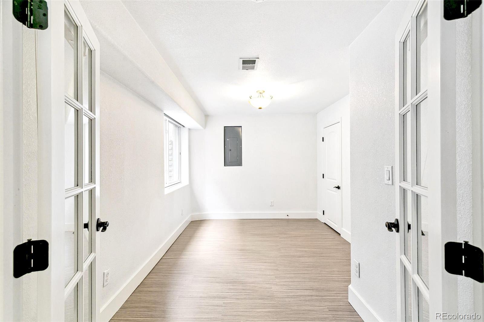 4530 Quitman Street Denver, CO 80212 - Photo 41 of 50 a view of a hallway with wooden floor and cabinet