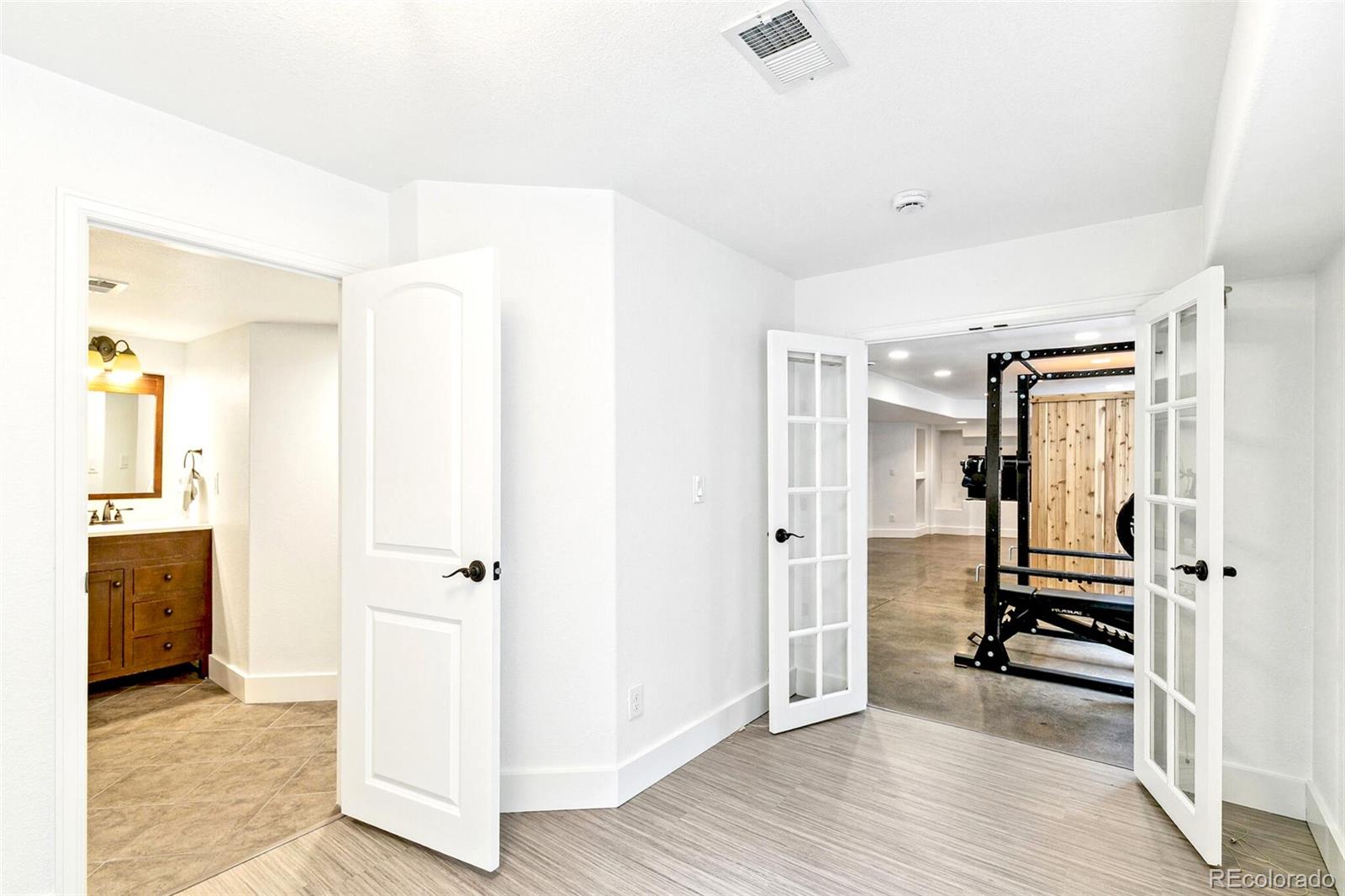 4530 Quitman Street Denver, CO 80212 - Photo 42 of 50 a view of a hallway with wooden floor and a bathroom