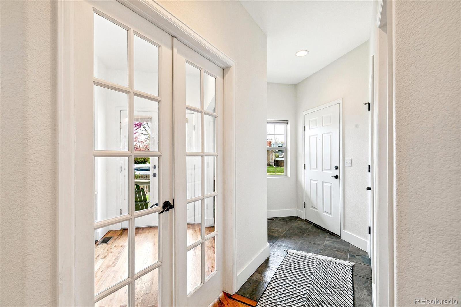 4530 Quitman Street Denver, CO 80212 - Photo 5 of 50 a view of a bedroom with a bed and wooden floor