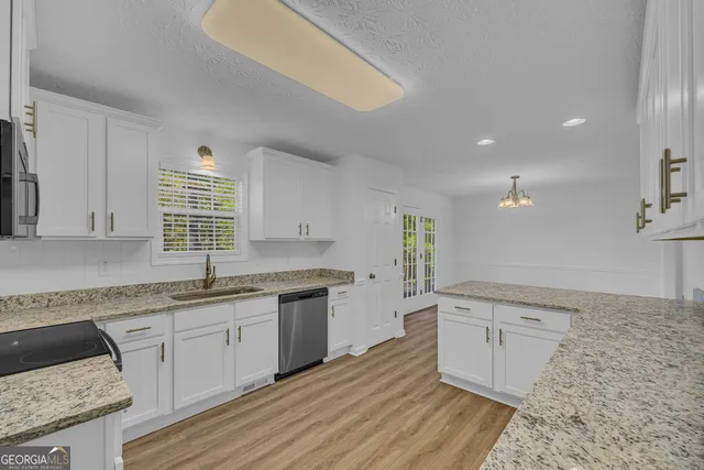 a large kitchen with a sink and cabinets