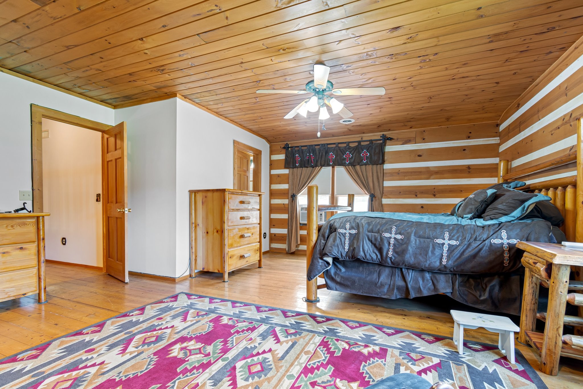 1321 Maddox Road Centerville, TN 37033 - Photo 60 of 70 a bedroom with a bed and a chandelier