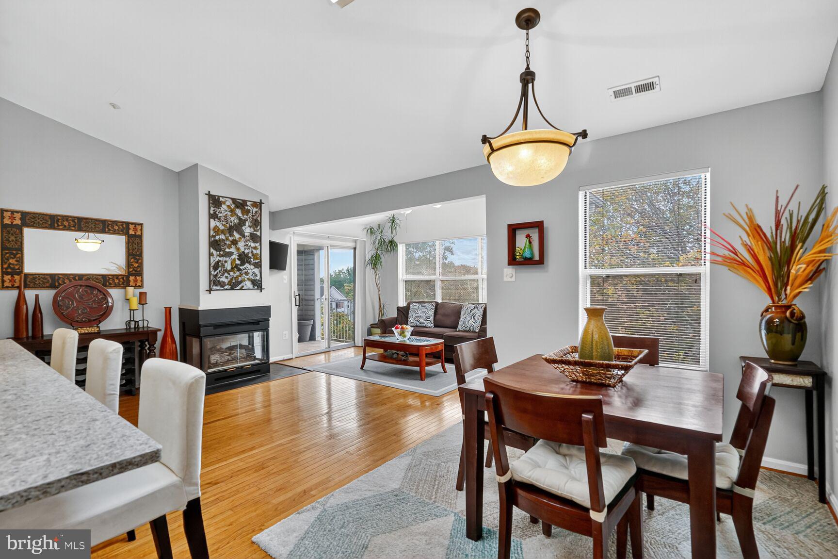 14101 Valleyfield Drive, Unit 114 Silver Spring, MD 20906 - Photo 1 of 26 a living room with fireplace furniture and a wooden floor