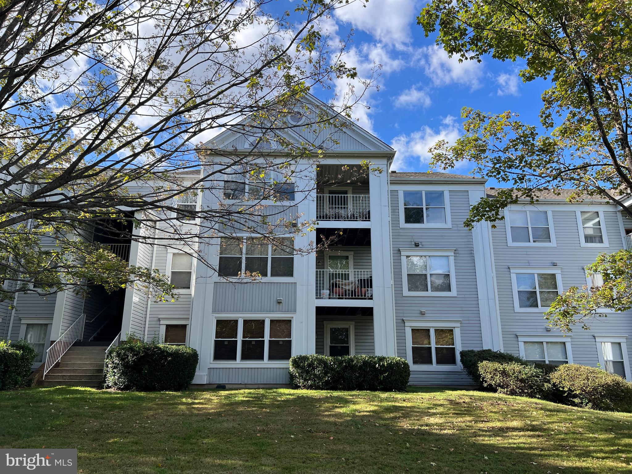 14101 Valleyfield Drive, Unit 114 Silver Spring, MD 20906 - Photo 16 of 26 a front view of a building with a garden