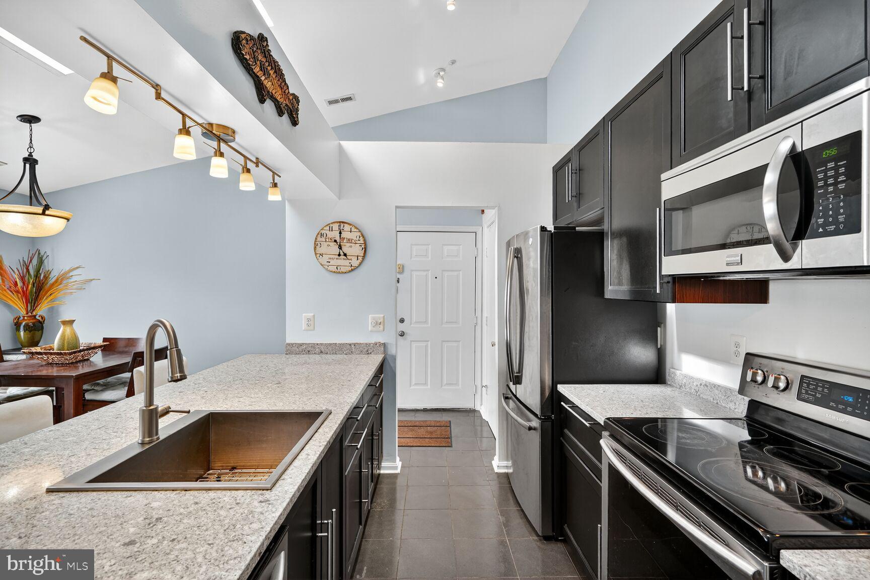 14101 Valleyfield Drive, Unit 114 Silver Spring, MD 20906 - Photo 3 of 26 a kitchen with stainless steel appliances granite countertop a sink stove and refrigerator