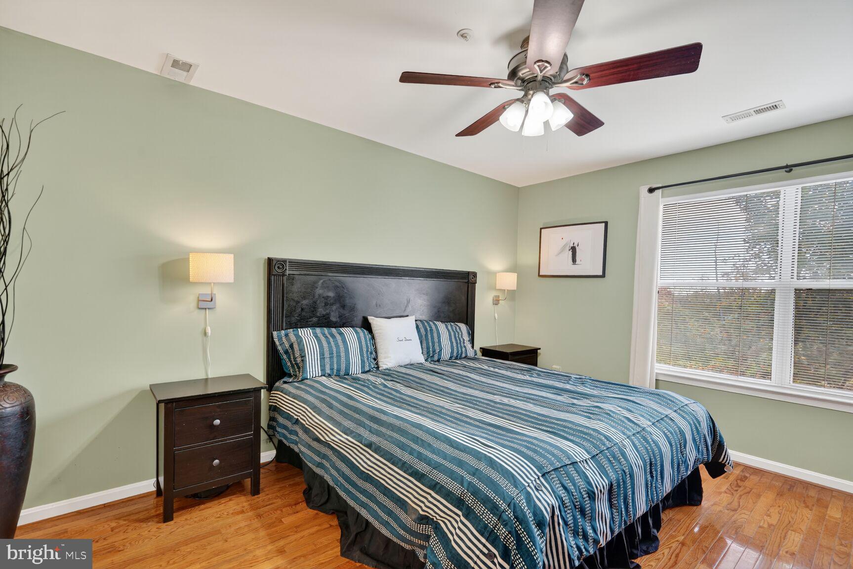 14101 Valleyfield Drive, Unit 114 Silver Spring, MD 20906 - Photo 6 of 26 a bedroom with a bed and a window