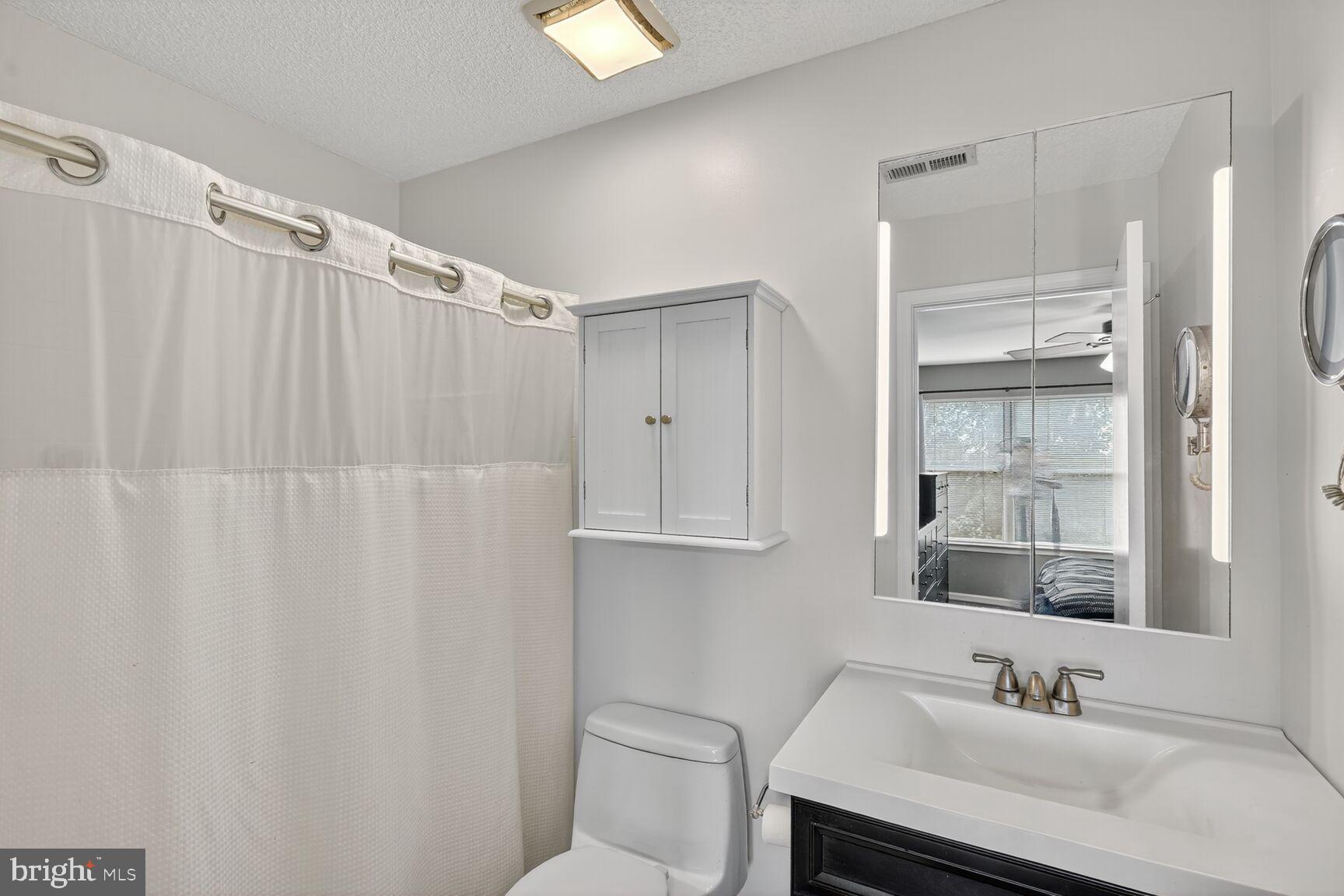 14101 Valleyfield Drive, Unit 114 Silver Spring, MD 20906 - Photo 8 of 26 a bathroom with a sink and a mirror