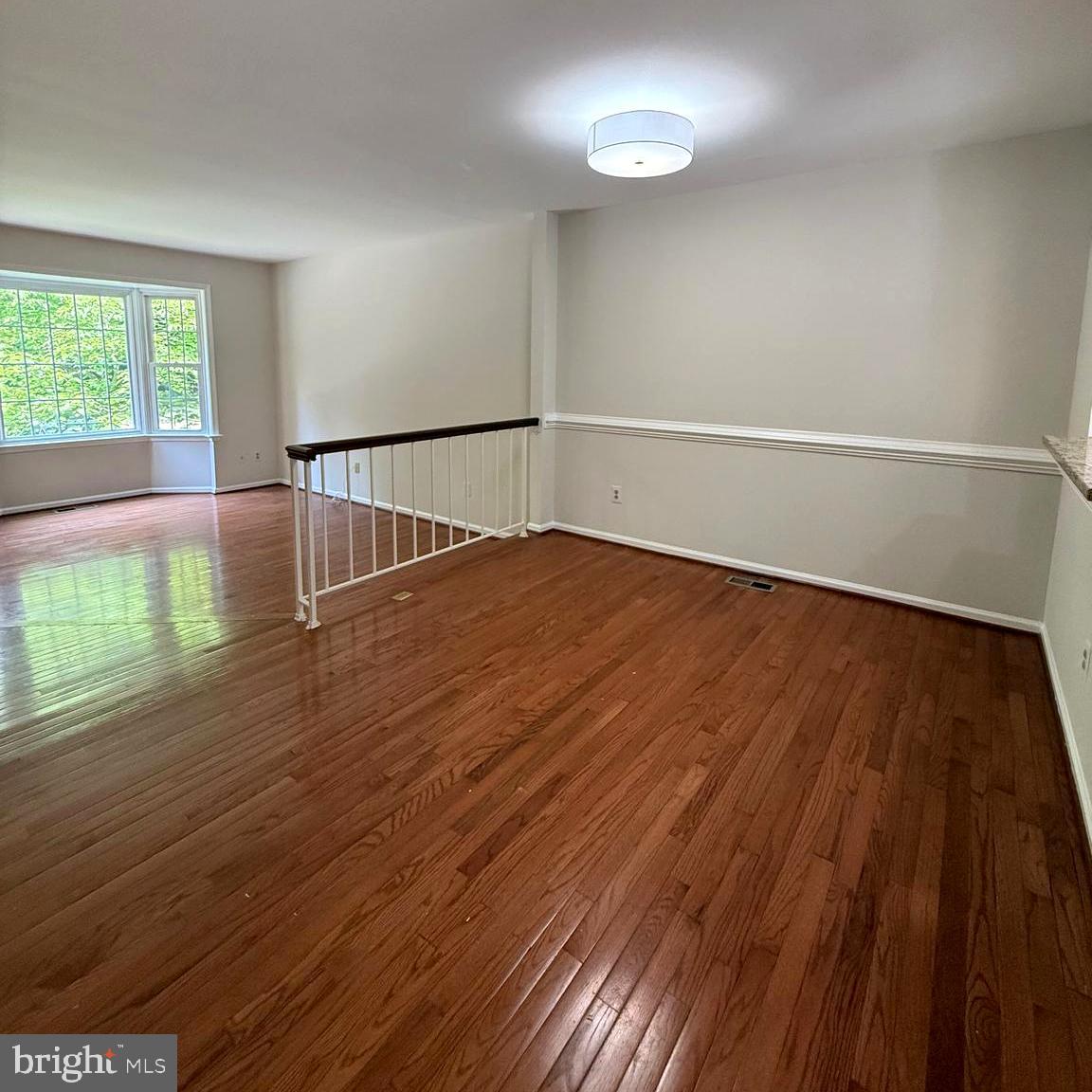 8442 Springfield Oaks Drive Springfield, VA 22153 - Photo 5 of 31 an empty room with wooden floor and windows