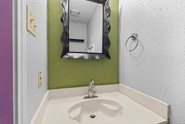 a bathroom with a sink and a mirror