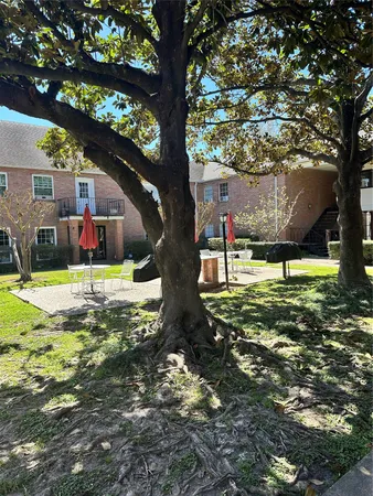 a view of backyard with a barn and large trees