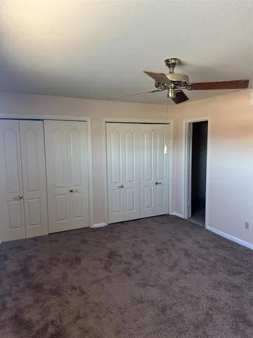 a view of room with a ceiling fan