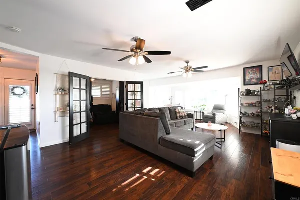 a living room with furniture and wooden floor