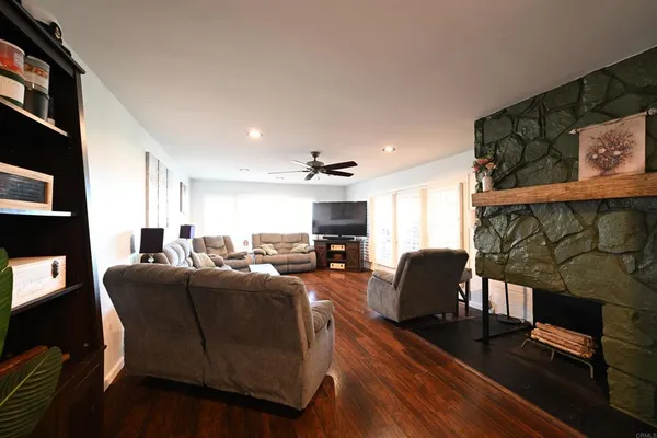 a living room with furniture a fireplace and a flat screen tv
