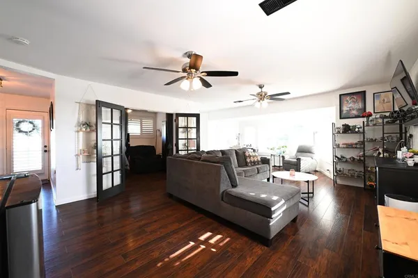 a living room with furniture and wooden floor
