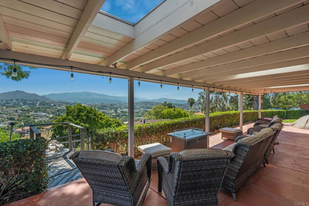 1308 Sundale Road El Cajon, CA 92019 - Photo 17 of 70 a view of a patio with lawn chairs floor to ceiling window and wooden floor