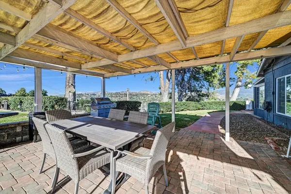 a view of a backyard with sitting area