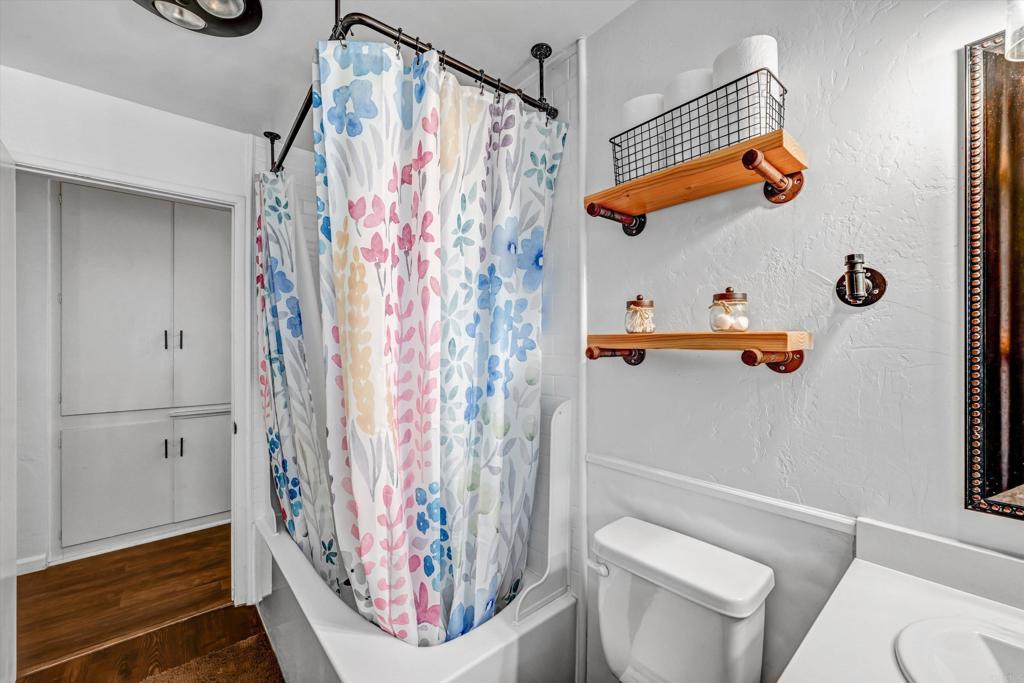 1308 Sundale Road El Cajon, CA 92019 - Photo 30 of 70 a bathroom with a toilet and shower curtain