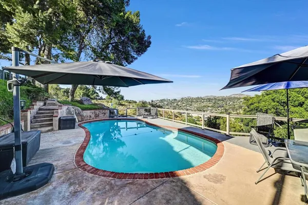 a view of a swimming pool with a patio