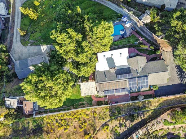 an aerial view of a house with a yard and garden