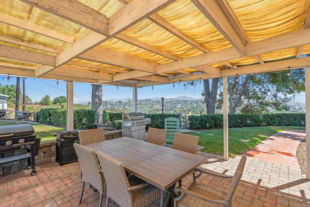 1308 Sundale Road El Cajon, CA 92019 - Photo 42 of 70 a view of a patio with a table chairs and a backyard